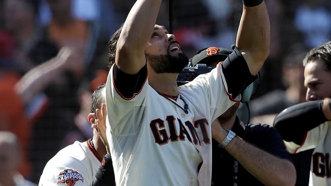 The San Francisco Giants' Angel Pagan celebrates after hitting an inside-the-park home run off of Colorado Rockies pitcher Rafael Betancourt to win the game in the tenth inning in San Francisco.