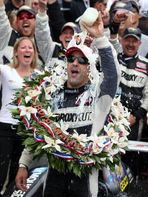 Tony Kanaan pours a bottle of milk over his head after winning during the 2013 Indianapolis 500.