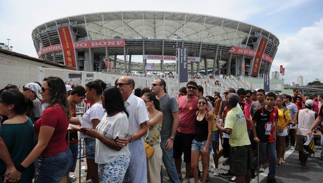 In a file photo from April 7, fans are seen outside of the "Arena Fonte Nova" stadium during its official inauguration in Salvador de Bahia, Brazil.