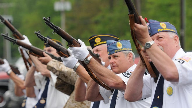 An honor guard fires a volley during a Memorial Day Ceremony at the American Legion Post 568 in Stevensville, Mich.