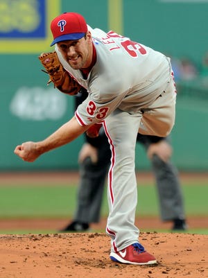 Philadelphia Phillies starting pitcher Cliff Lee (33) pitches during the first inning against the Boston Red Sox at Fenway Park.