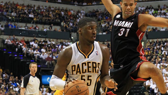 Indiana Pacers center Roy Hibbert (55) drives to the basket as Miami Heat small forward Shane Battier (31) defends.