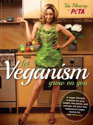 Tia Mowry promotes veganism for PETA, wearing a lettuce apron created by Mia Gyzander.