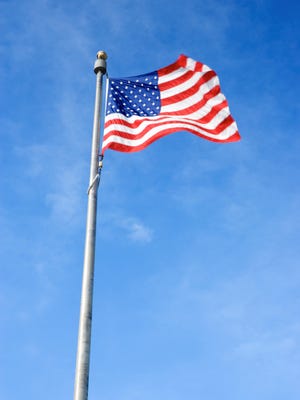 An American flag is displayed on a flagpole.