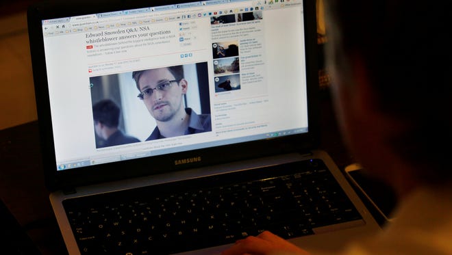Tom Grundy, an activist, blogger and co-organizer supporting Edward Snowden's campaign, browses the live chat with Snowden on the 'Guardian' website in his house in Hong Kong on Monday.