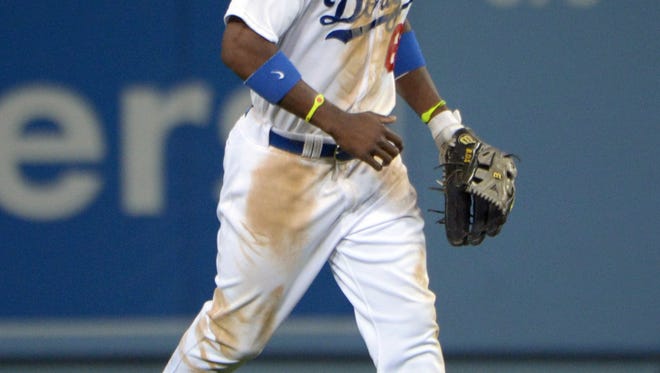 Los Angeles Dodgers right fielder Yasiel Puig celebrates at the end of the game against the San Francisco Giants at Dodger Stadium.