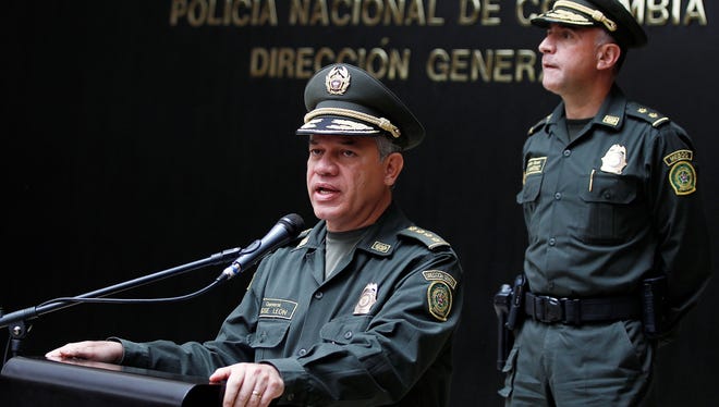 Colombia's National Police Chief Gen. Jose Roberto Leon Riano, left, talks to the media as Metropolitan Police Commander Gen. Luis Martinez looks on at police headquarters in Bogota, Colombia, June 25.