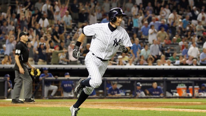 New York Yankees outfielder Ichiro Suzuki hits a game-winning home run in the bottom of the ninth inning against the Texas Rangers at Yankee Stadium.