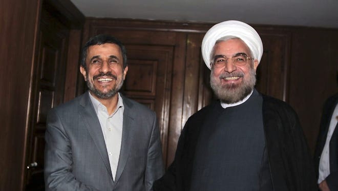 Outgoing Iranian President Mahmoud Ahmadinejad, left, and President-elect Hasan Rowhani in Tehran last week.