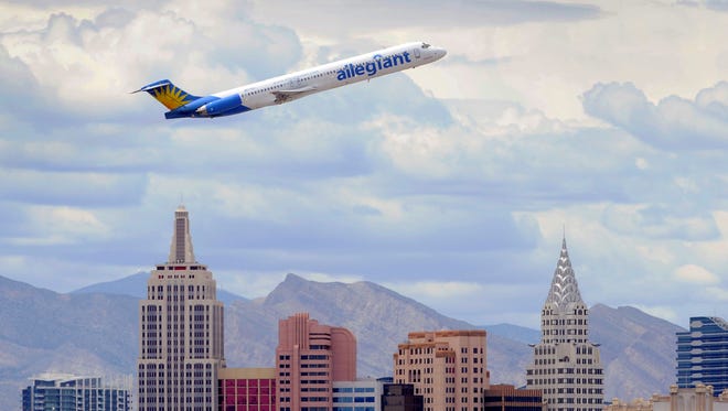 An Allegiant Air plane flies over the the the New York-New York Hotel , Casino after taking off from McCarran International Airport in Las Vegas.