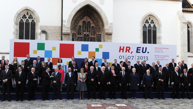 European Commission President Jose Manuel Barroso (1st row, 5thL), European parliament President Martin Schulz (1st row, 7thL) and European Council President Herman Van Rompuy (1st row, 7thR) pose among European officials during the family photo in front of St. Mark church in Zagreb.