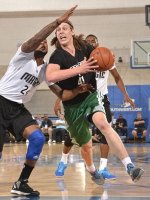 Celtics center Kelly Olynyk drives to the basket against pressure from Magic defenders in a summer league game Sunday.