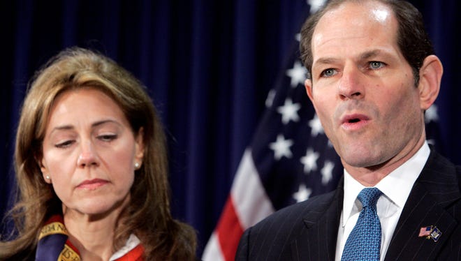 New York Gov. Elliot Spitzer announces his resignation as his wife Silda stands by his side, March 12, 2008, in his offices in New York City.
