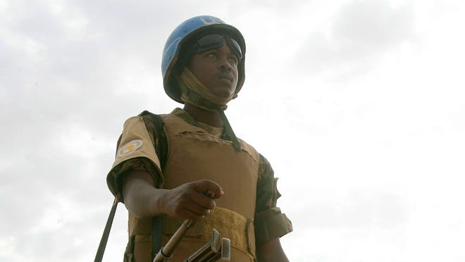 This picture taken in Oct. 2012, shows a Union-United Nations Mission in Darfur (UNAMID) soldier standing guard at the internally displaced persons' (IDP) Abushok camp in El-Fasher, in Sudan's North Darfur state. U.N. officials met Tuesday to discuss the need for additional involvement in Darfur.