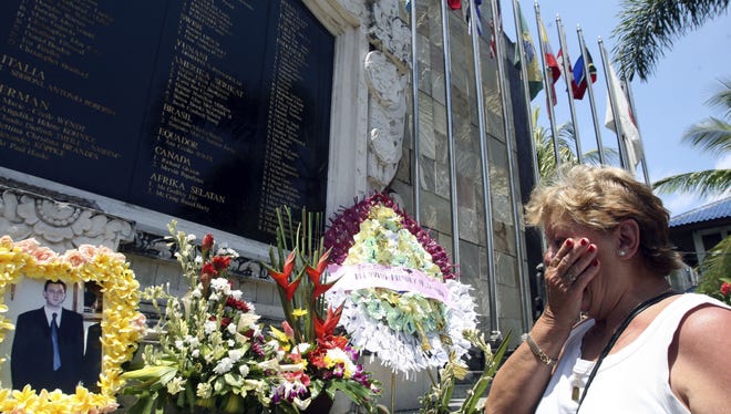 Australian Carmen Cacha, who lost her son in the 2002 Bali bombings pays her respects at the Bali Memorial Monument on Thursday.  (AP Photo/Firdia Lisnawati)