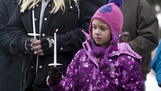 Alicia Caldwell and her daughter Maggie Boren, both originally from Newtown, Conn., during the community dedication of a grove of trees at the Salt Lake City cemetery in remembrance of victims of the Sandy Hook Elementary shootings, Thursday.