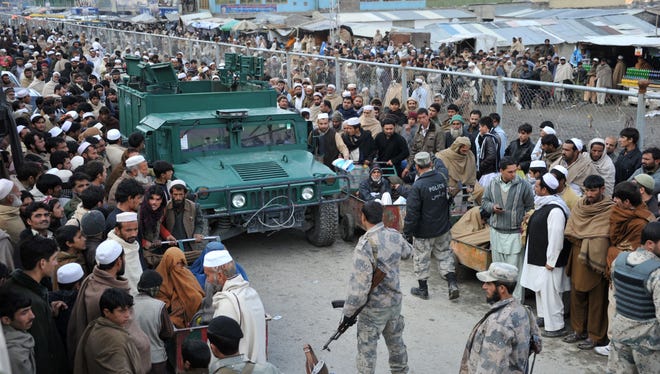 Afghans wait in the main border crossing at Torkham, between Afghanistan and Pakistan east of Kabul on Saturday.