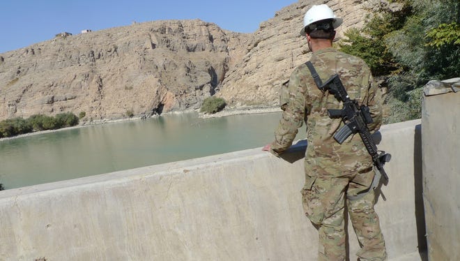 A U.S. Marine looks out at the lake formed by the Kajaki dam in Helmand province, south of Kabul, Afghanistan.