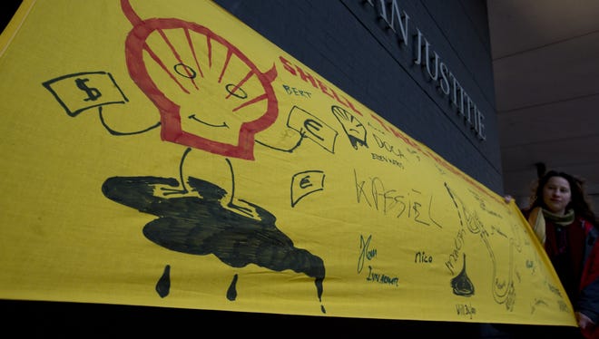 A Friends of the Earth banner outside court ahead of the case of Nigerian farmers against Shell, in The Hague, Netherlands.
