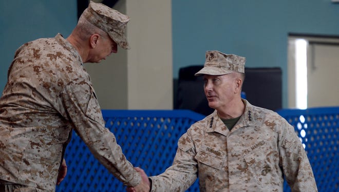 U.S. Marine Gen. Joseph Dunford, right, shakes hand with outgoing NATO commander U.S. Gen. John Allen during a change of command ceremony at the ISAF headquarters in Kabul.