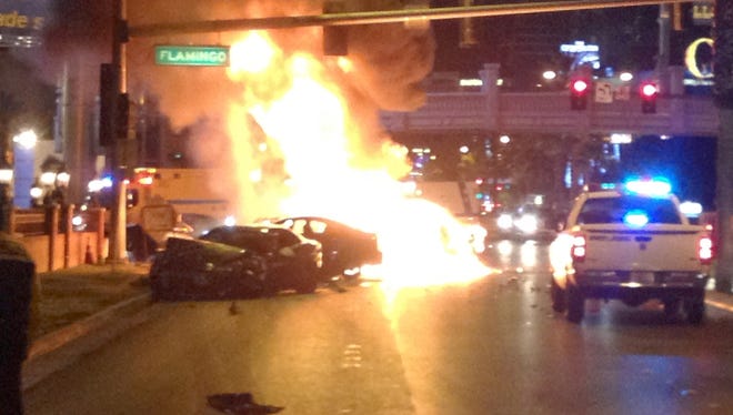 Smoke and flames billow from a burning vehicle following a shooting and multi-car accident on the Las Vegas Strip, Feb. 21, 2013.