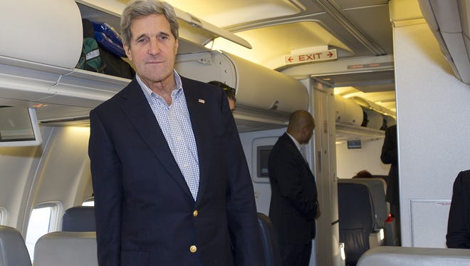 U.S. Secretary of State John Kerry talks to reporters traveling abroad with him shortly after finding out their aircraft had a mechanical problem before takeoff Saturday.