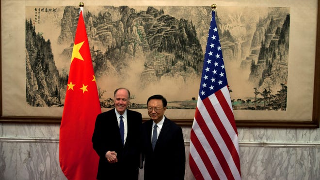 U.S. National Security Adviser Tom Donilon and Chinese State Councilor Yang Jiechi, shake hands before their meeting in Beijing on Monday.