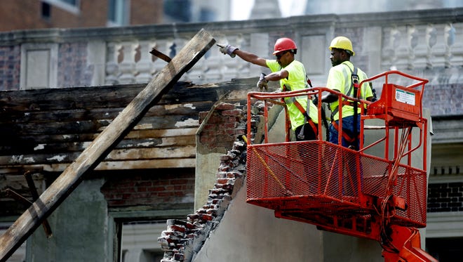 Workers at the scene of a building collapse in Philadelphia.