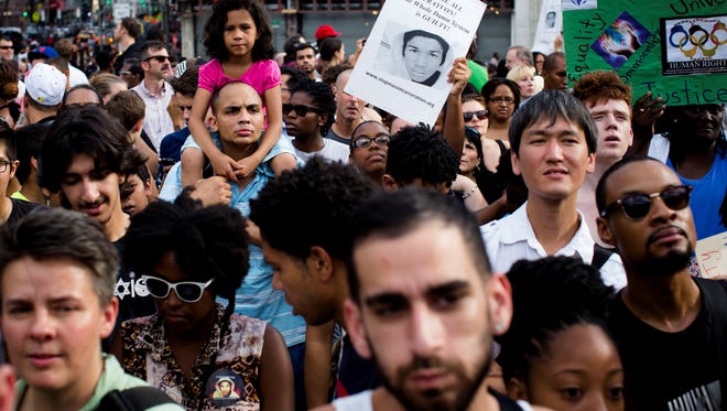 Demonstrators converge on Union Square, on July 14, 2013, in New York, during a protest against the acquittal of neighborhood watch member George Zimmerman in the killing of 17-year-old Trayvon Martin in Florida.