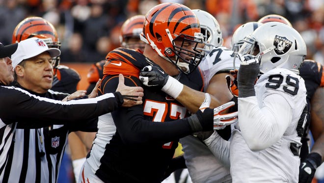 Bengals tackle Andrew Whitworth (77) fights with Raiders defensive end Lamarr Houston (99) in the second half Nov. 25 in Cincinnati. Both players were ejected.