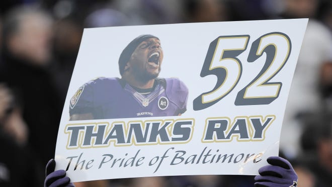 A Baltimore Ravens fan holds a Baltimore Ravens ' Ray Lewis sign during the first half of an NFL wild card playoff football game against the Indianapolis Colts.