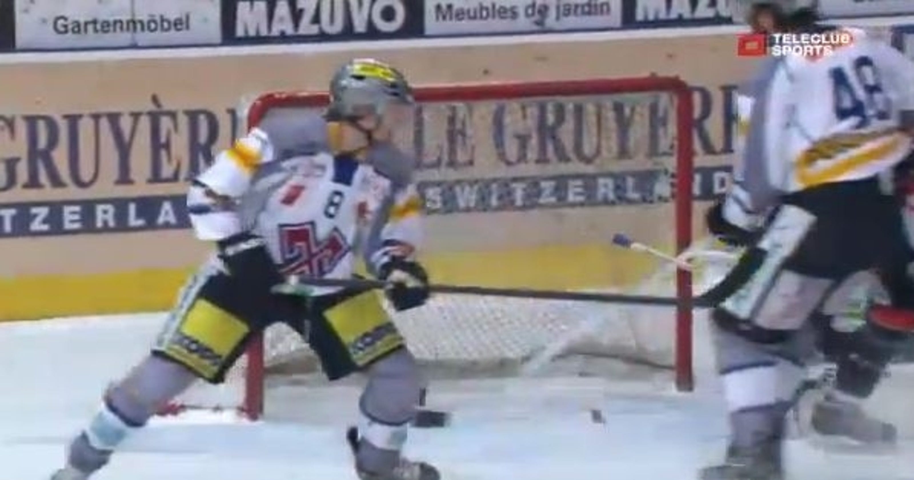 Hockey puck hits the post, splits in two pieces