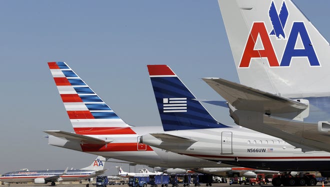 US Airways and American Airlines planes at DFW International Airport on Feb. 14, 2013.