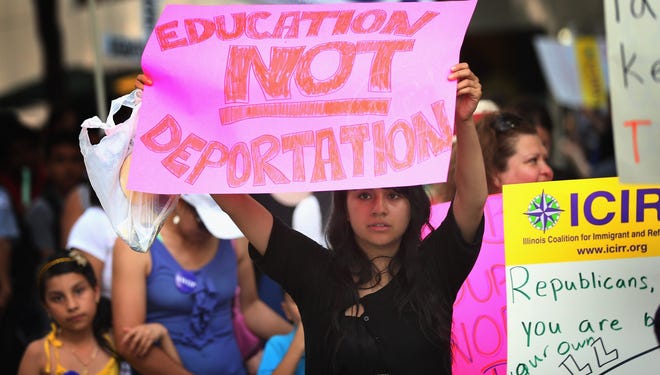 Protesters demonstrate calling for immigration changes in front of the Illinois GOP headquarters on June 27 in Chicago.