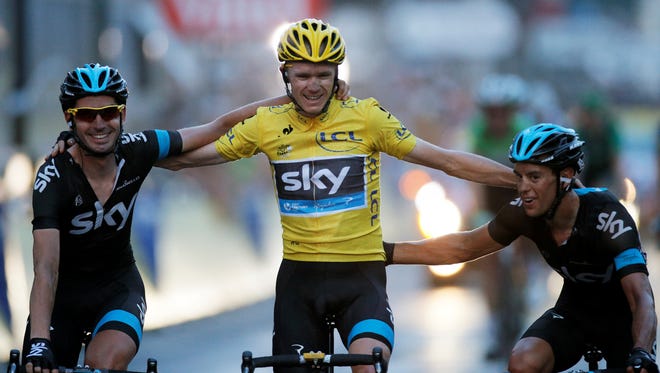 Tour de France winner Christopher Froome of Britain, wearing the overall leader's yellow jersey, crosses the finish line of the 21st and last stage of the 100th edition of the Tour de France in Paris Sunday. He finished with his Sky teammates.