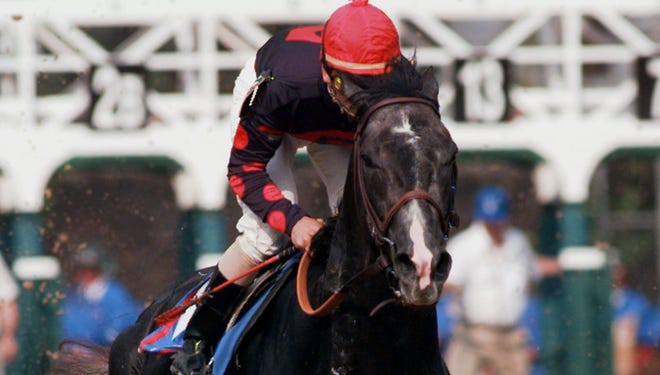 Mike Smith rides Unbridled's Song out of the gate at the start of the 1996 Kentucky Derby,  which he lost to Grindstone. The prolific sire died Friday at the age of 20.