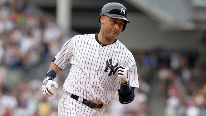 Derek Jeter rounds the bases Sunday after hitting a home run on the first pitch he saw since returning from the DL.