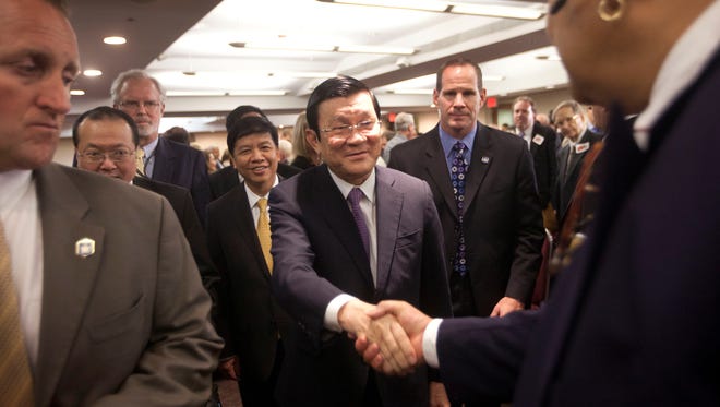 Vietnam's president, Truong Tan Sang, center, greets the audience at the Center for Strategic and International Studies in Washington on Thursday.