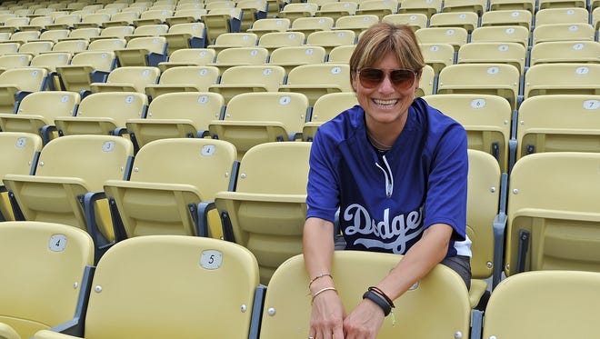 Los Angeles Dodgers head trainer Sue Falsone watches players warm up before a game last week against the Cincinnati Reds  at Dodger Stadium.