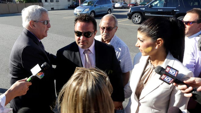 Teresa Giudice, 41, and her husband Giuseppe "Joe" Giudice, 43, of Montville Township, N.J., walk toward Martin Luther King Jr. Courthouse before a court appearance today in Newark.