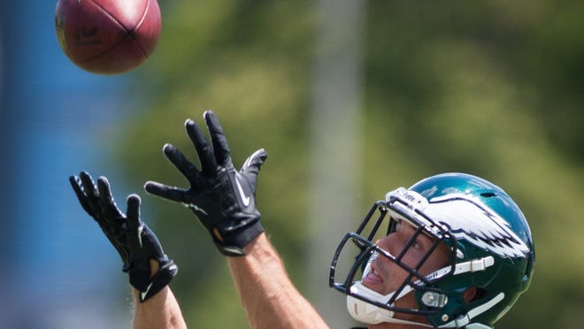 Philadelphia Eagles wide receiver Riley Cooper stretches for a pass but comes up short as he runs through drills at NFL football training camp in Philadelphi.