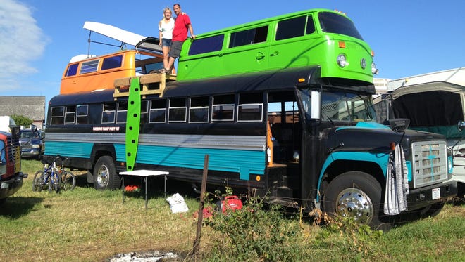 Sheri and Donny Rector show off their buses on top of a bus
