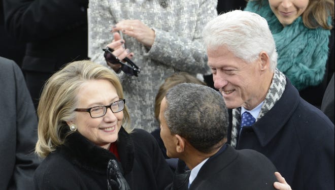 President Obama and the Clintons mingle at the public inauguration on Monday.