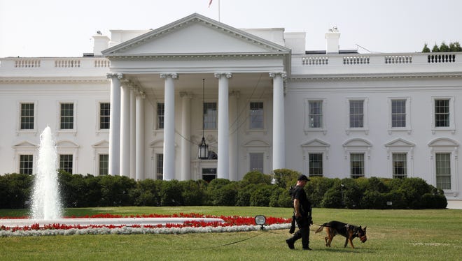A Secret Service dog patrols the White House.