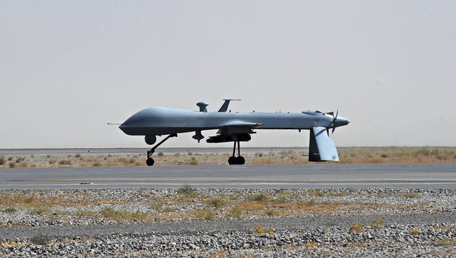 A U.S. Predator unmanned drone armed with a missile sits on the tarmac at Kandahar military airport in Afghanistan.