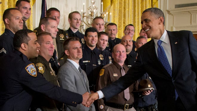 President Obama shakes hands with New York City Police Detective Ivan Marcano