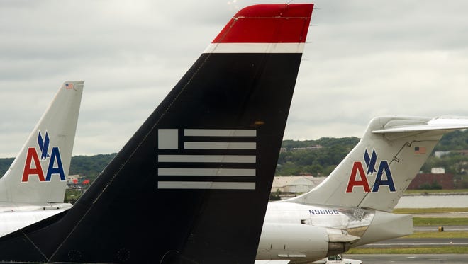 US Airways and American Airlines planes are seen at Ronald Reagan Washington National Airport in Arlington, Va., on April 23, 2012.