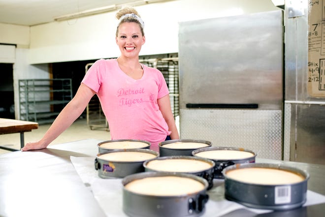 KorrieLinn DeLand poses next to some of her cheesecakes that she made on Thursday, July 19, 2018, at the Pizza Crust Company in Lansing. DeLand got her baking start at Sidestreets Deli, a small eatery in Charlotte that she managed. Since June her cheesecakes have been in such demand that she's left the eatery and started her own wholesale business.
