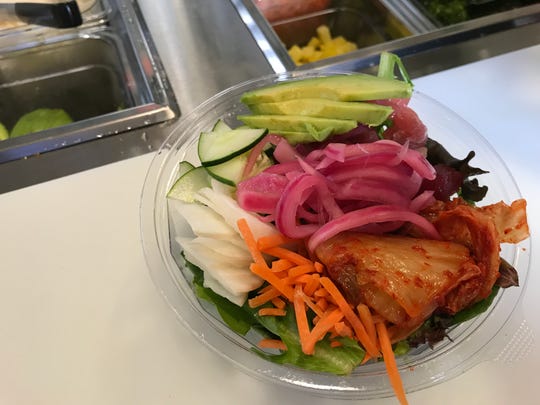 Tuna, daikon, avocado, carrots, kimchi, cucumbers on citrus-dressed greens at Poké Guru. The build-your-own poké bowl stand opened July 23, 2018, at Indianapolis City Market in Downtown Indy.