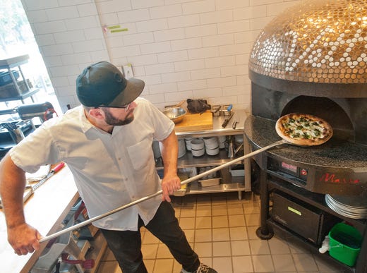 bar Vetti Executive Chef Andrew McCabe pulls a spring vegetable pizza out of the oven.
July 10, 2018